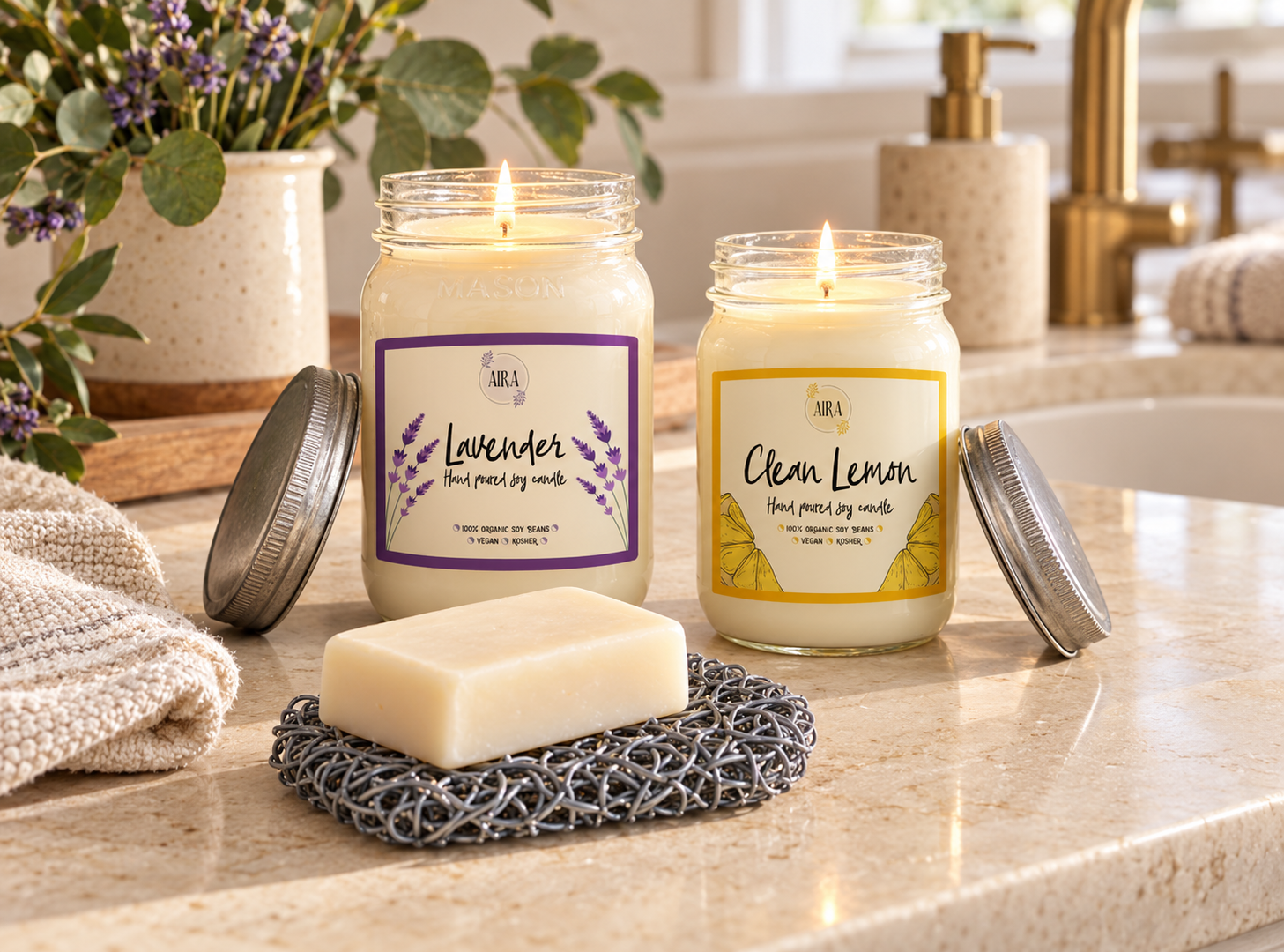 Aira 16 ounce Lavender and 12 ounce Clean Lemon candles with a bar of soap on an Aira soap saver