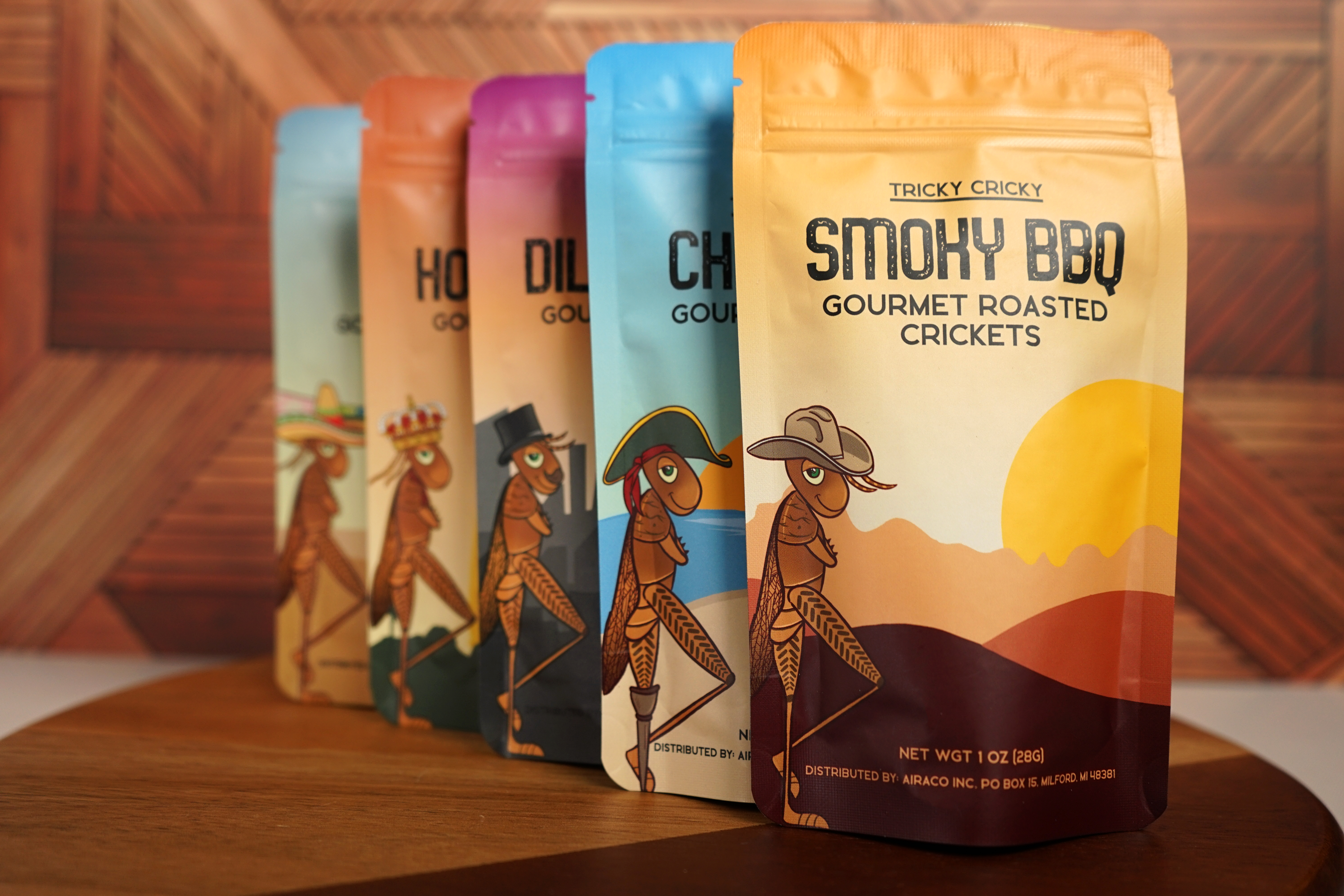 Tricky Cricky gourmet roasted cricket flavors on a wooden board